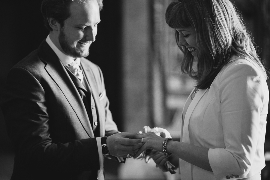 Bride and groom exchanging rings during ceremony in Stockholm CIty Hall